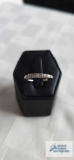 Silver colored ring marked 14K with 6 stone diamond band, 1/4 karat total weight, size 7.
