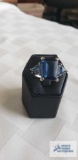 Silver colored ring with large blue stone and two smaller blue stones, marked LNT 925 IN,