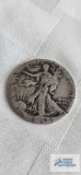 Walking Liberty half dollar coin, year not legible
