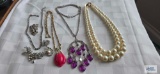 Sarah Covington purple beaded necklace and rose-colored tulip necklace. Double strand pearl like