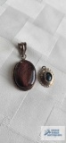 Silver colored brown stone pendant, marked 925 and green stone pendant, marked Sterling, 9.9 G