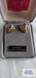 Gold colored earrings with pinkish stone and clear surrounding stones, marked 925
