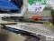 Three aluminum baseball bats and one wooden baseball bat
