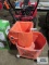 Orange commercial mop bucket, made by White