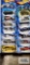 Fourteen 2004 Roll Patrol Hot Wheels cars, new in packages.