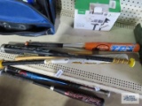 Three aluminum baseball bats and one wooden baseball bat