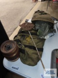Independence wooden barrel safe, metal door needs reattached. Army bags and World War II placard.