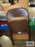 Three brown metal folding chairs