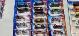 Sixteen 2004 First Editions Tooned Hot Wheels cars, new in packages