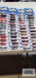 Fifty-six 2000 First Editions Hot Wheels cars, new in packages
