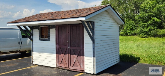 12' 3" long by 8' 3" wide by 9' tall Shed with 3' 6-1/2" overhang on front. 11' 9-1/2" total width
