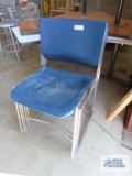 Five metal and plastic stacking chairs