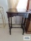 Antique accent table with turned legs.