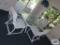 Glass top outdoor table with four armchairs. On first floor.