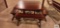 Redwood outdoor table with four benches, umbrella, and umbrella base. Umbrella has damage on top. in