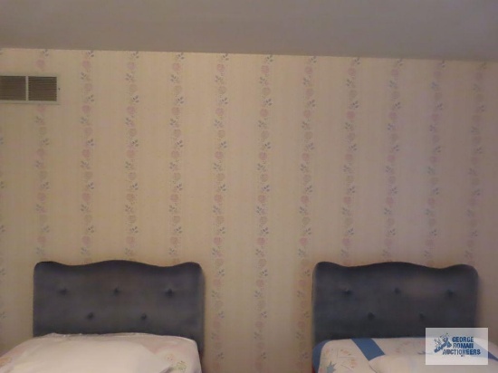 Pair of twin beds with upholstered headboards. On second floor. No mattresses or bedding included.