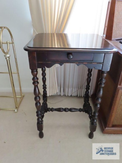 Antique accent table with turned legs.