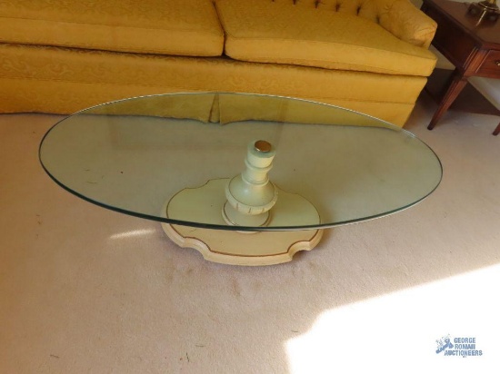Glass top coffee table with French provincial style base. On first floor.