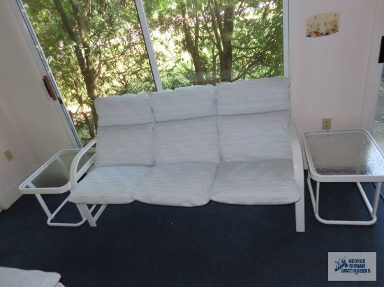 Outdoor sofa with two end tables.
