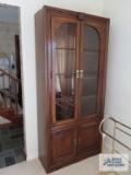 Fruitwood china cabinet with bottom storage. On first floor.