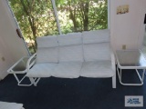 Outdoor sofa with two end tables.