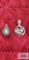 Silver color pendant with green and marcasite stones and other silver colored pendant, both marked