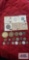 Variety of foreign coins, some in coin holders.