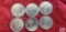 Six Canadian one dollar coins