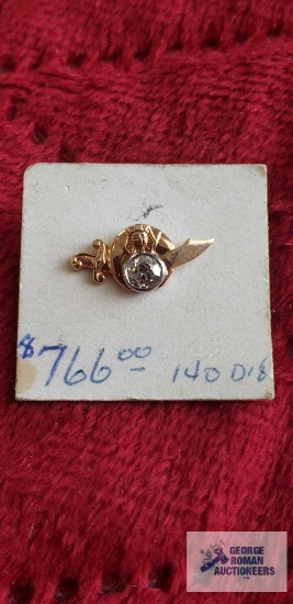 Gold colored sword tie tack with clear gemstone, marked 14K.