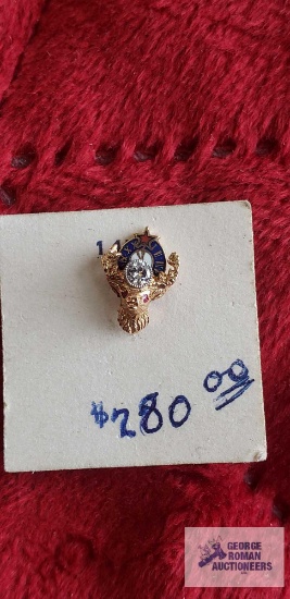 Gold colored deer head tie tack with clear gemstone, marked 14K.