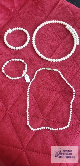 Costume jewelry pearl like necklaces and bracelets.