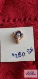 Gold colored deer head tie tack with clear gemstone, marked 14K.