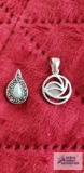 Silver color pendant with green and marcasite stones and other silver colored pendant, both marked