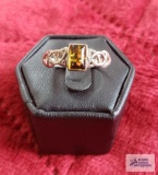 Silver colored ring with amber stone, marked 925.