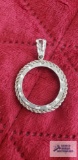 Silver colored circle pendant, marked 925.