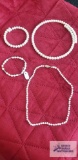 Costume jewelry pearl like necklaces and bracelets.