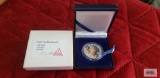 1965 Colorized Kennedy half dollar coin.