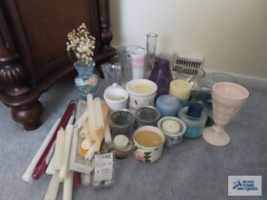 Assorted candles, candle holders, and vases