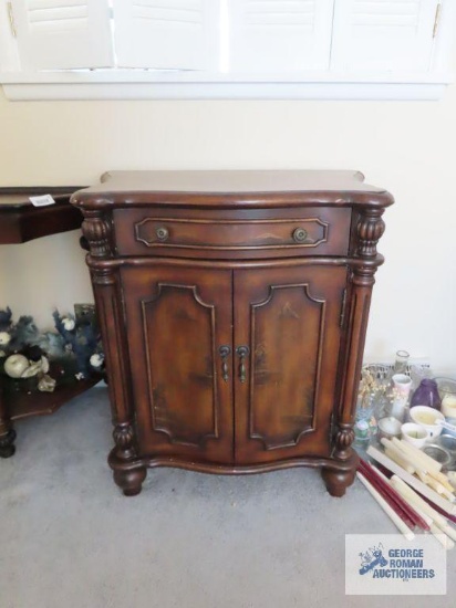 Cherry finish cabinet with oriental design