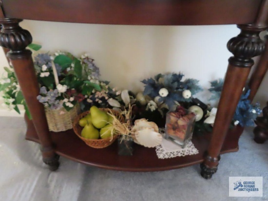 Assorted seashells, woven bowl with artificial fruit, basket with florals, and other floral items