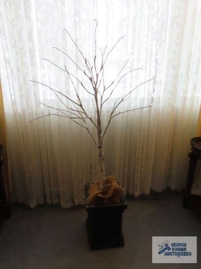 Artificial lighted tree in ceramic planter. approximately 4' tall.