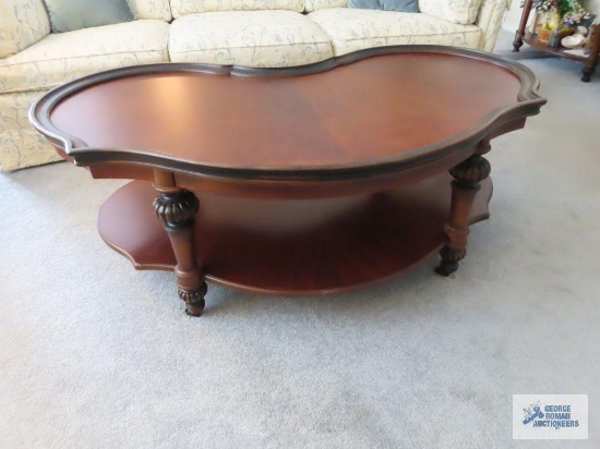 Cherry finish kidney shaped coffee table.