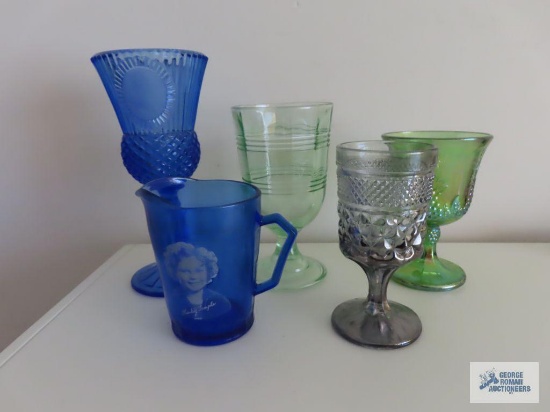 Cobalt blue Shirley Temple creamer, blue and green stemware, green Carnival Glass stemware, and