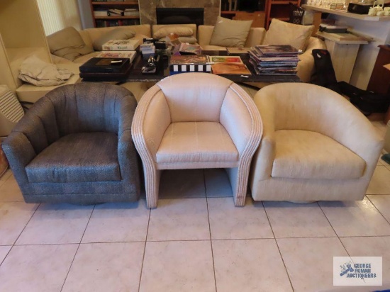 Three non-matching barrel back chairs, two swivel