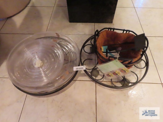 Hanging metal planters, roll about plant stands, and plastic plant liners