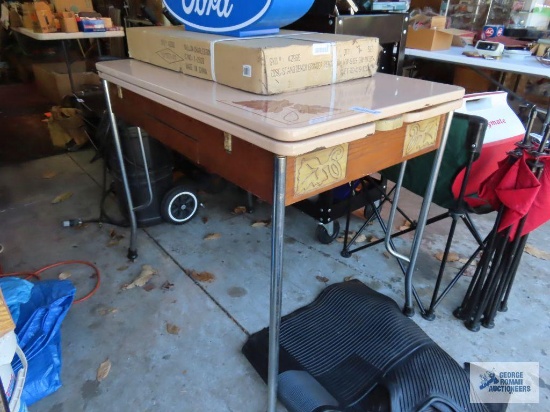 Vintage dining room table with pull-out leaves and enamelware top