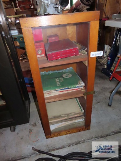 Vintage automotive books and glass front cabinet