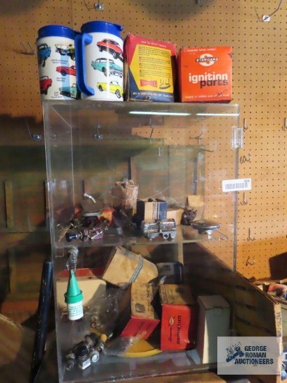 New Old Stock and used automotive parts in display cabinet. Comes with plastic display