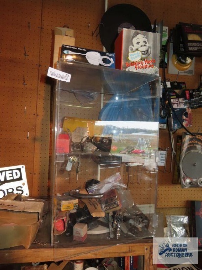 New Old Stock and used automotive parts in display cabinet. Comes with plastic display