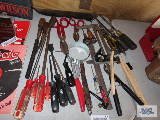 Screwdrivers, oil filter wrench, tin snips, and other tools